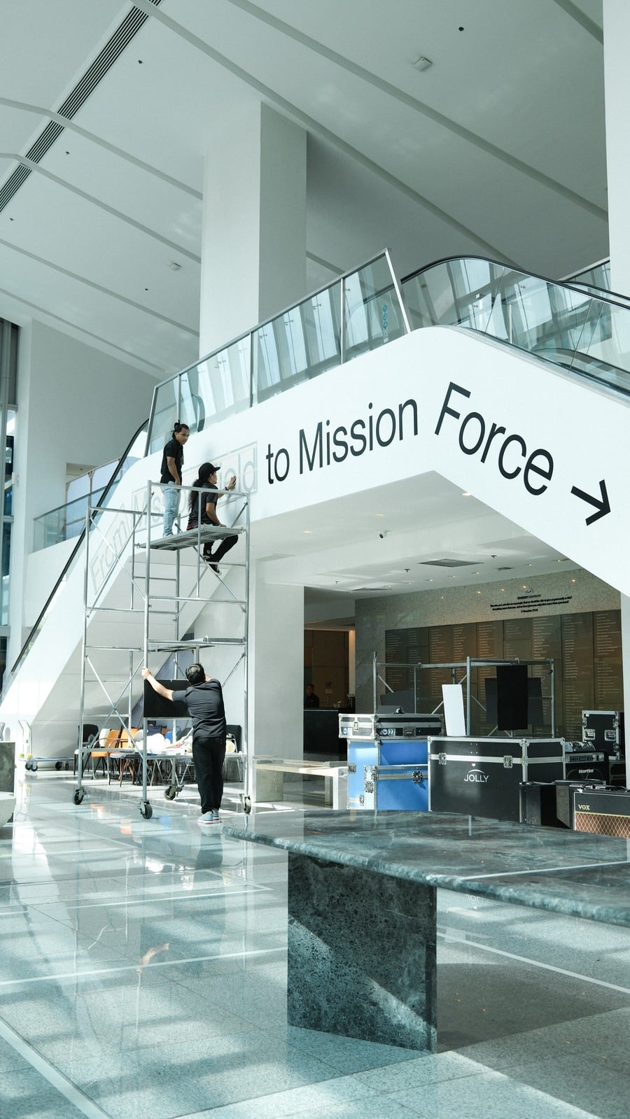 Omnisource team installing a Mission Force wall display